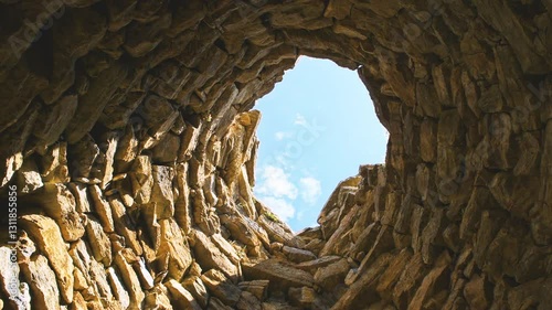 Wallpaper Mural Nuraghe Su Nuraxi 'e Pauli in Seulo, Sardinia looking up low angle view on tower wall of rock stone material, ancient ruins in Italy Torontodigital.ca