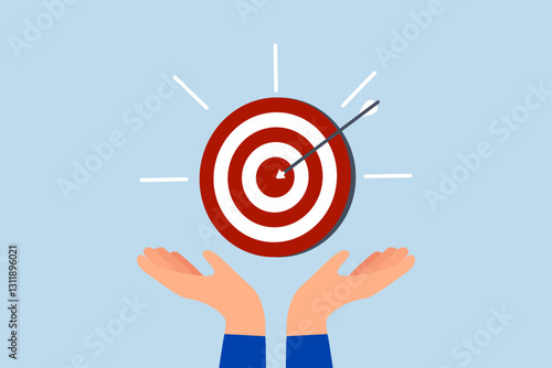 Goal, businessman hand hold target with arrow hit bullseye.