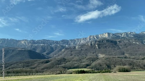 view from window of moving car to mountains along road