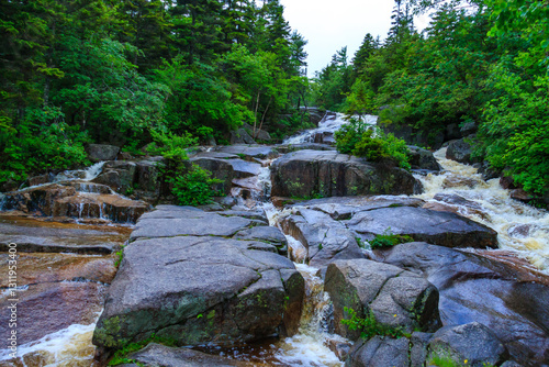 Cuadro en lienzo A small mountain river flows along a stone cascade of small waterfalls, Hiking W