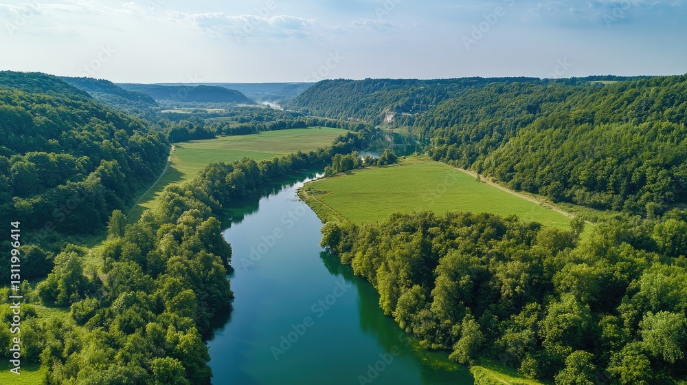 Fototapeta premium Aerial View of Serene River Winding Through Lush Green Valley