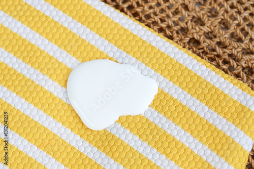 Schilderij op canvas Sunscreen stains in a swimsuit yellow striped and a straw beach bag