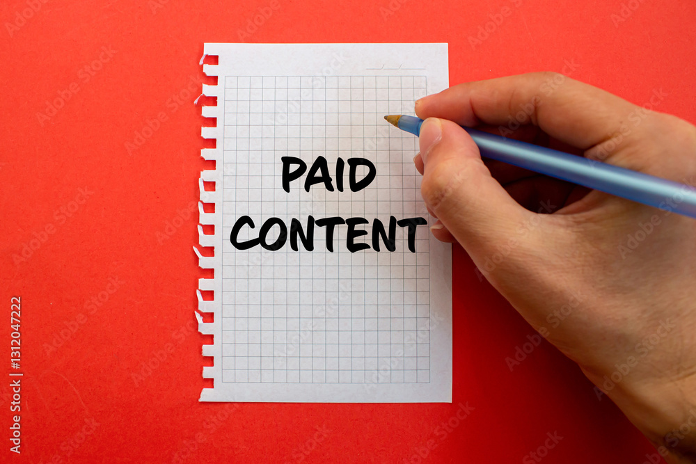 Paid content message written on white paper on red background. Conceptual paid content symbol. Copy space. Paid content message written on white paper on red background. Conceptual paid content symbol. Copy space.