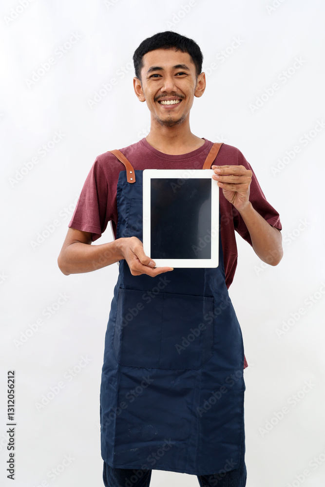 Young asian man barista barman employee wear blue apron work in coffee shop hold use tablet pc computer blank screen workspace area isolated on white background Small business startup concept Young asian man barista barman employee wear blue apron work in coffee shop hold use tablet pc computer blank screen workspace area isolated on white background Small business startup concept