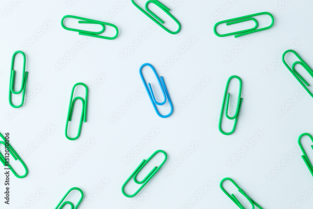 Many paper clips on light background, flat lay Many paper clips on light background, flat lay