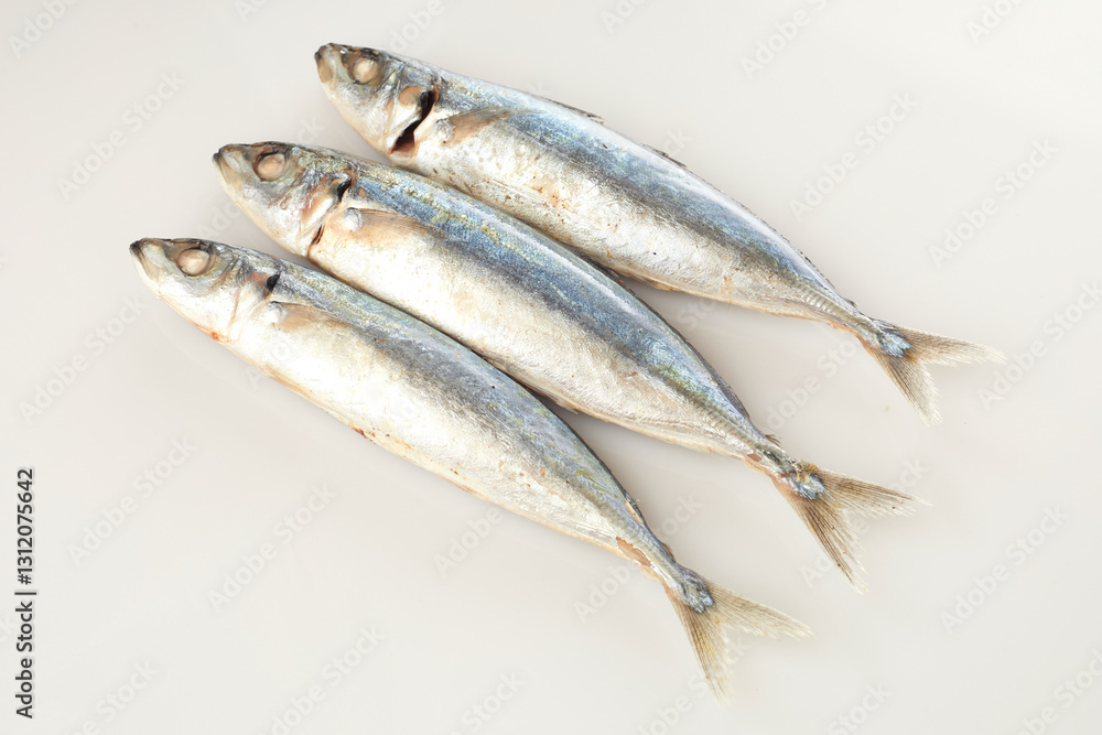 Isolated in White Background, Three Fresh Fish Arranged Symmetrically With Shiny Scales and Intact Features Isolated in White Background, Three Fresh Fish Arranged Symmetrically With Shiny Scales and Intact Features