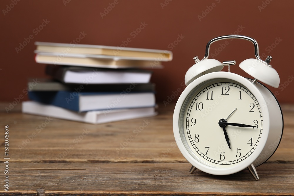 Time for knowledge. Alarm clock and books on wooden table, closeup. Space for text Time for knowledge. Alarm clock and books on wooden table, closeup. Space for text