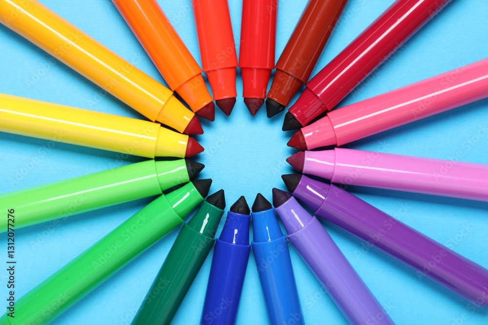 Naklejka premium Many colorful markers on light blue background, flat lay