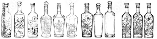 Variety of decorative glass bottles with floral designs lined up on a white background