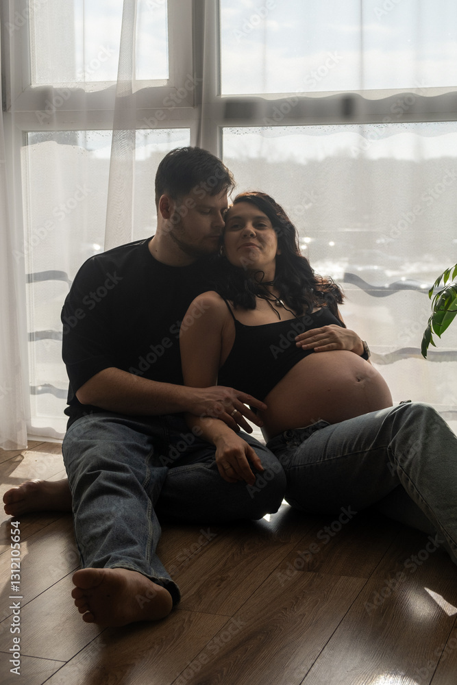 Intimate Moment of Expecting Parents by the Window