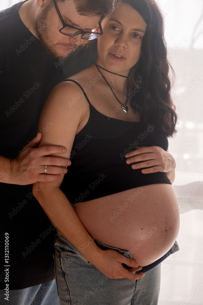 Intimate Moment of Expecting Parents by the Window