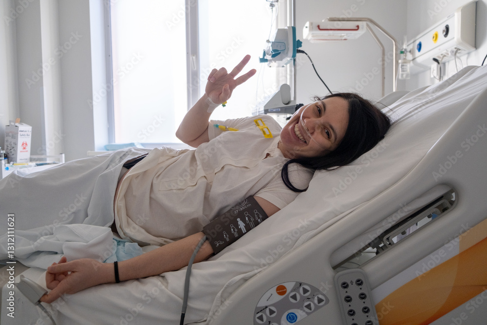 Smiling Patient in Hospital Bed Making Peace Sign