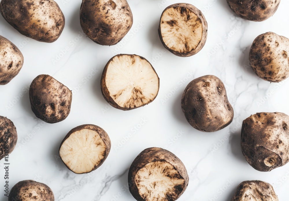 Fototapeta premium Fresh Raw Potatoes Displayed on Marble Surface, Various Shapes and Sizes, Healthy Cooking Ingredient, Natural Food Background for Culinary Use