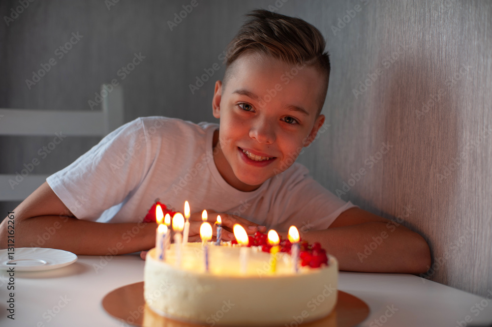 Smiling young boy leaning on a table with a lit birthday cake, enjoying a joyful celebration in a cozy setting. Smiling young boy leaning on a table with a lit birthday cake, enjoying a joyful celebration in a cozy setting.