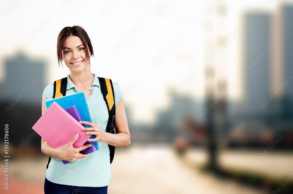 A young happy woman student holds notebooks A young happy woman student holds notebooks