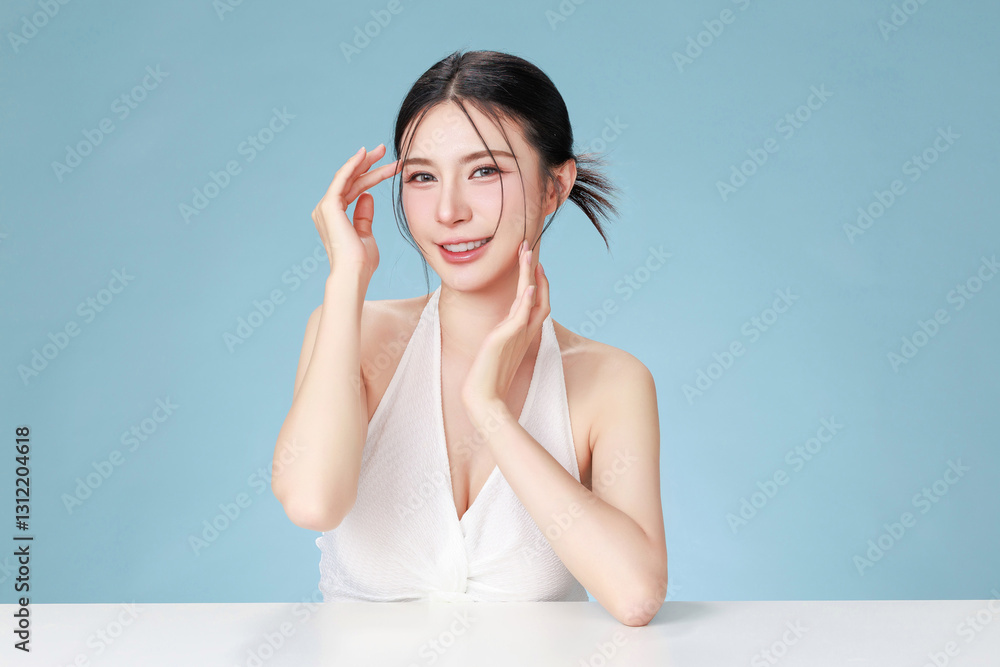 Beautiful young Asian woman model bun hair with natural makeup on face clean fresh skin on isolated blue background. Cute girl portrait, Facial treatment, Body care, Beauty and Spa. Beautiful young Asian woman model bun hair with natural makeup on face clean fresh skin on isolated blue background. Cute girl portrait, Facial treatment, Body care, Beauty and Spa.