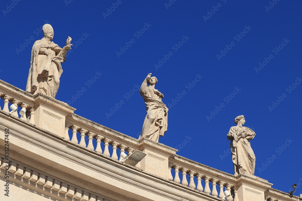 Obraz premium Saint Peter's Colonnade Detail with balustrade, Statues and Blue Sky in Rome, Italy, March 2025
