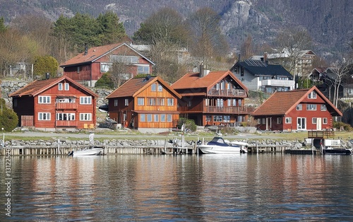 Traditional Red Wooden Houses By A Norwegian Fjord