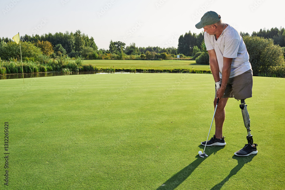 A dedicated golfer with a prosthetic leg focuses on his swing on a vibrant green course surrounded by nature in warm sunlight A dedicated golfer with a prosthetic leg focuses on his swing on a vibrant green course surrounded by nature in warm sunlight