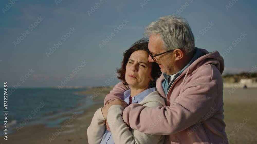 Happy laughing senior man hugging woman on sea beach at sunset in evening. Elderly couple family on date cuddling embracing talking. Lifelong relationships romantic marriage, enjoy leisure concept. Happy laughing senior man hugging woman on sea beach at sunset in evening. Elderly couple family on date cuddling embracing talking. Lifelong relationships romantic marriage, enjoy leisure concept.