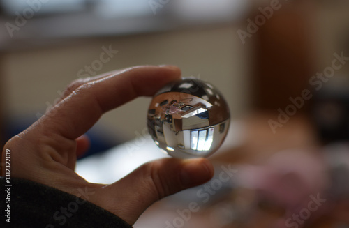 Flower Reflected Inside a Glass Ball Held by Hand, Macro Reflection Photography