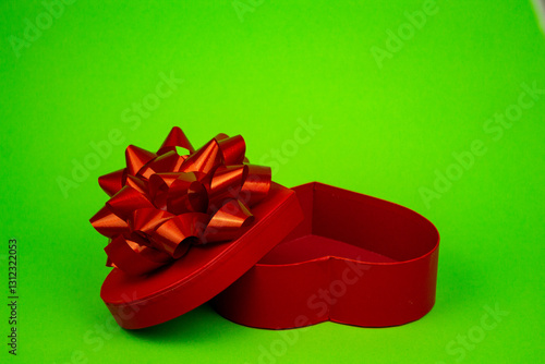 Valokuva Open red heart-shaped box close-up. Gift Box on Green Background