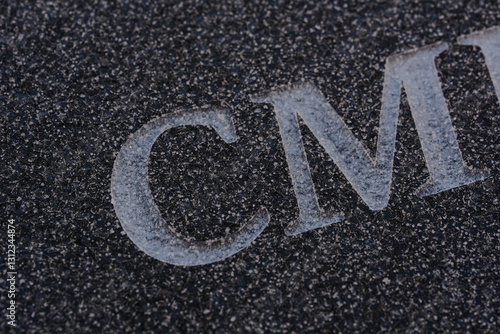 sandblasted letters and numbers on black granite
