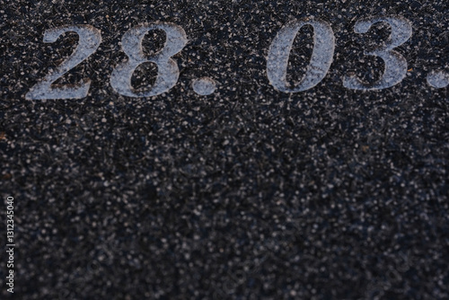 sandblasted letters and numbers on black granite