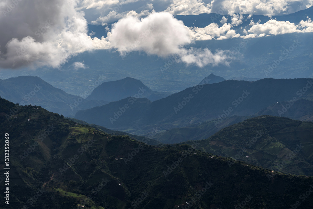 Obraz premium Rain clouds in dark tones in the Andean mountain range of Colombia, a dramatic landscape scene. Silhouette of mountains in the midst of a storm.