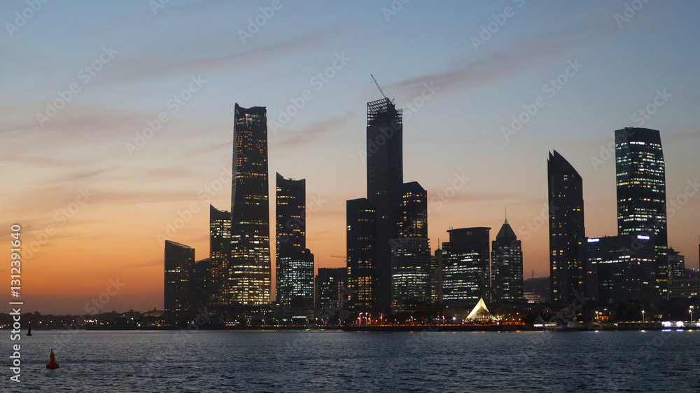 A Vibrant View of the Qingdao Skyline Illuminated by the Warm Hues of Sunset A Vibrant View of the Qingdao Skyline Illuminated by the Warm Hues of Sunset