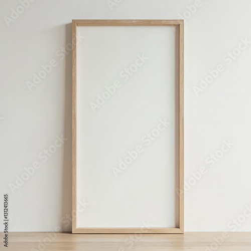Blank wooden picture frame against light wall and floor. Mockup template for art, photos. Modern minimalist interior decoration, home decor. Empty frame, copy space, portrait or landscape format.