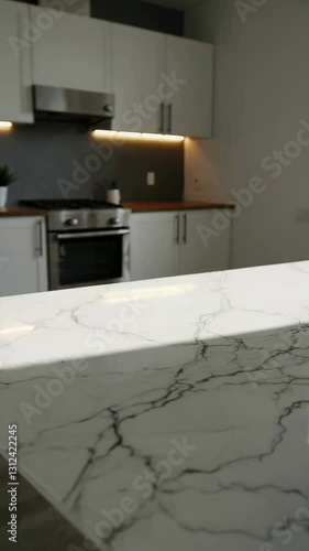 Sunlit modern kitchen with marble countertop and soft lighting transition