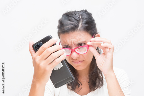 Quadro em tela woman with glasses reading with difficulty the cell phone, myopia, eye health