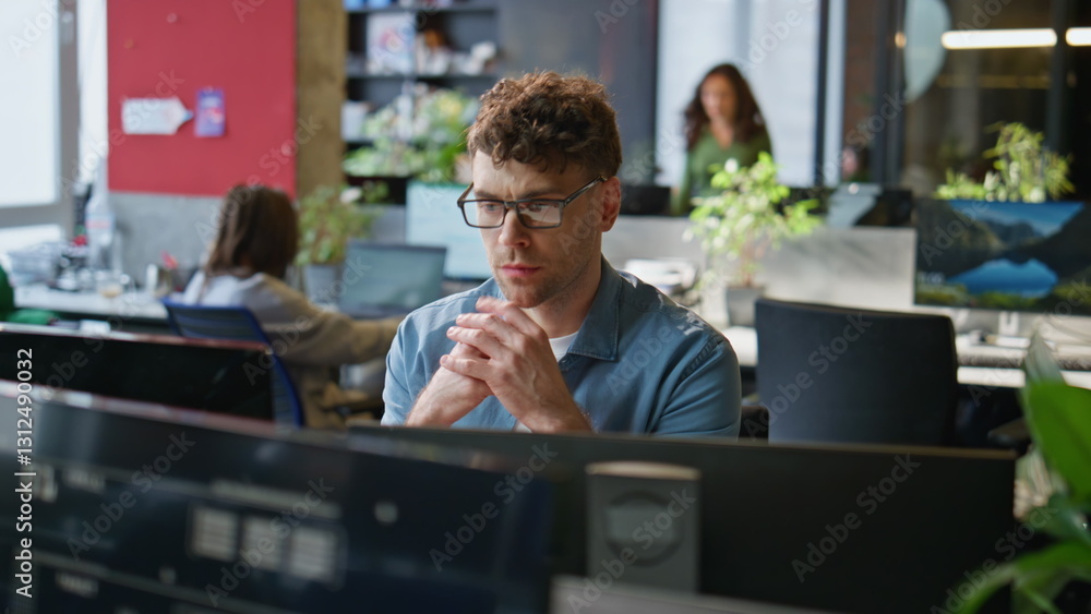 Attentive man thinking decision working computer in office interior closeup Attentive man thinking decision working computer in office interior closeup