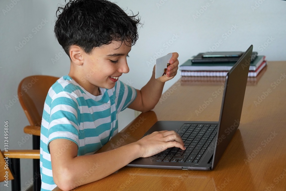 online shopping concept. teenage boy shopping online with a laptop gift card online shopping concept. teenage boy shopping online with a laptop gift card