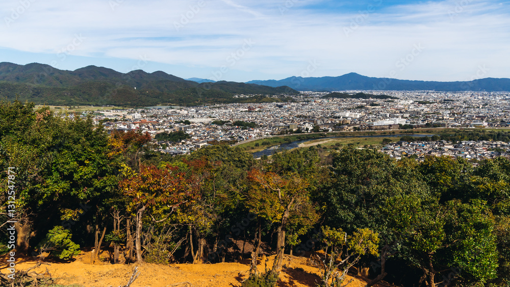 Obraz premium Kyoto panorama, Japan, beautiful super wide aerial view, with city skyline and mountains, seen from the observation deck in autumn fall sunny day with a blue sky, Kyoto prefecture, Kansai region
