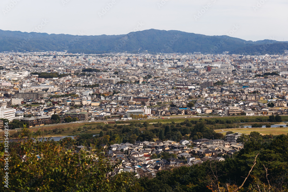 Obraz premium Kyoto panorama, Japan, beautiful super wide aerial view, with city skyline and mountains, seen from the observation deck in autumn fall sunny day with a blue sky, Kyoto prefecture, Kansai region