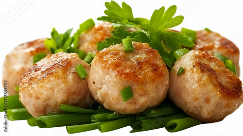 Delicious browned meatballs garnished with fresh green herbs and onions