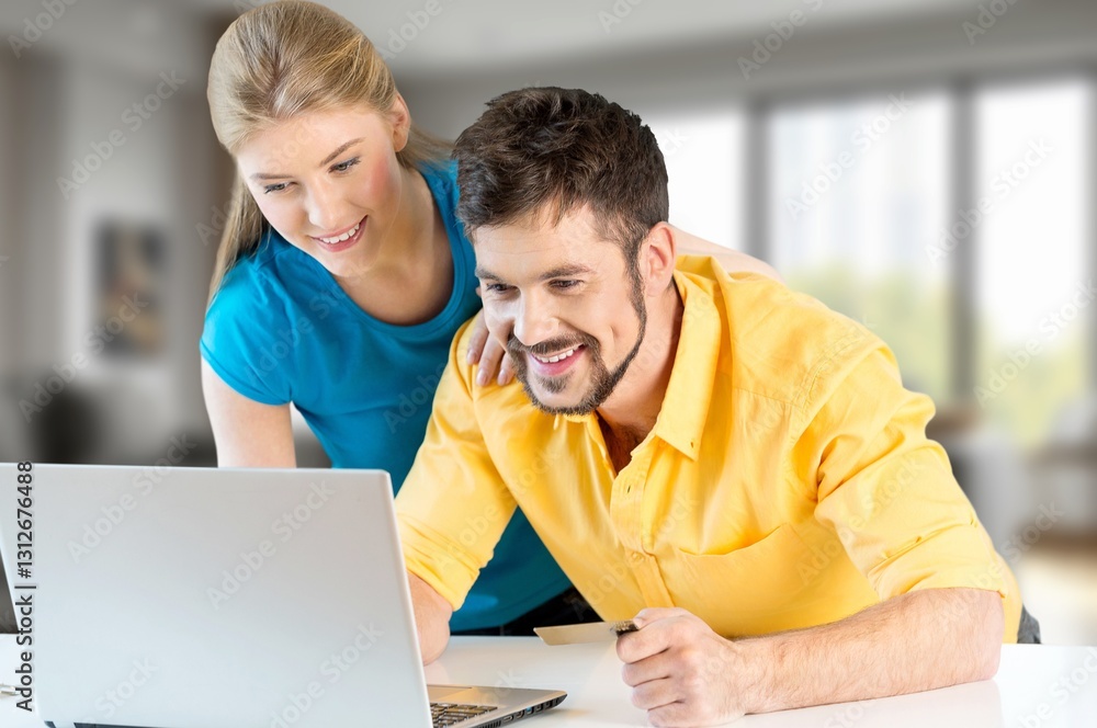 Happy couple paying bills planning at home Happy couple paying bills planning at home