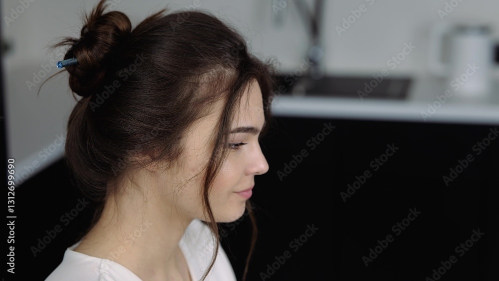 Young woman in kitchen during qurantine. Girl sit at table and working on laptop. Typing on its keyboard. Camera moves down from girl's head to her hands.Wrok from home remote. Young woman in kitchen during qurantine. Girl sit at table and working on laptop. Typing on its keyboard. Camera moves down from girl's head to her hands.Wrok from home remote.