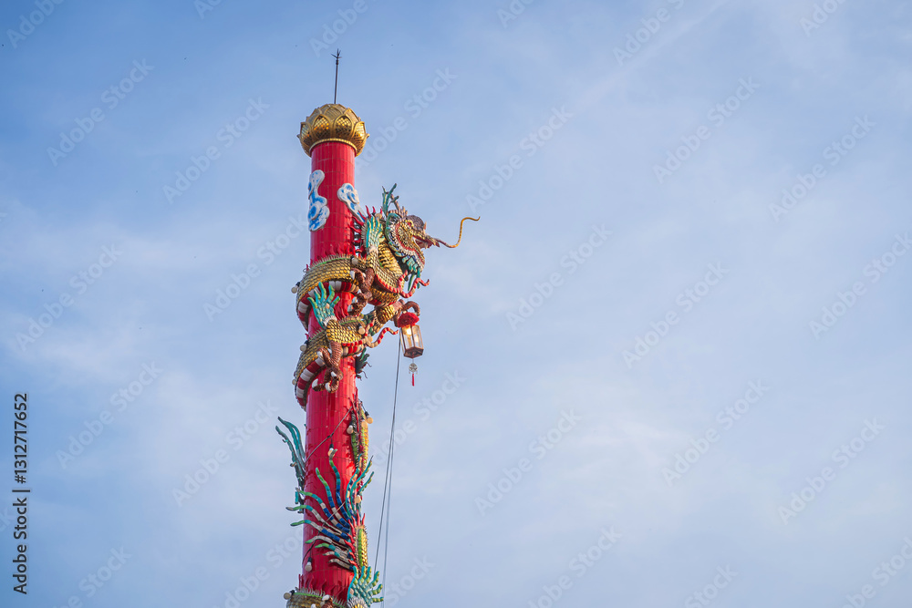 Beautiful Elegant double golden dragon statue on the roof of on a temple for Chinese New Year Festival at Chinese shrine with blue sky.