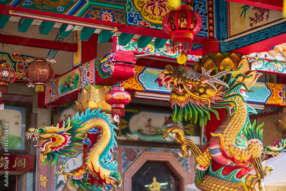 Beautiful Elegant double golden dragon statue on the roof of on a temple for Chinese New Year Festival at Chinese shrine with blue sky.