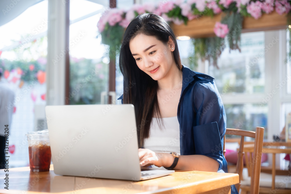 Asian freelance people business female talking making using casual working with laptop computer and coffee at home in the living room indoors artificial rose bouquet of red and pink roses rose vase