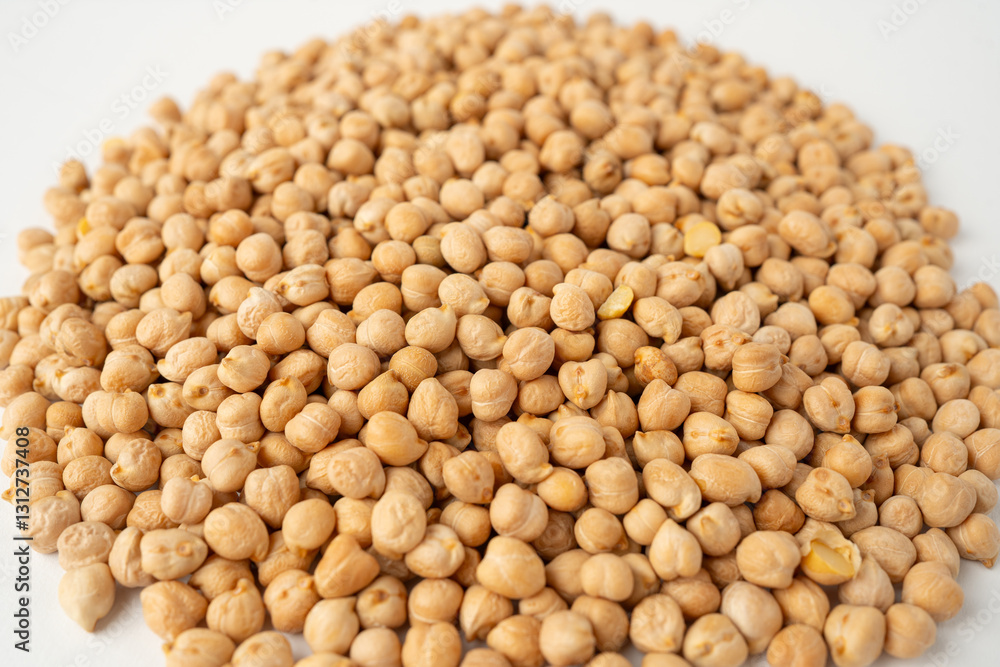 Many chickpeas scattered on a white background, isolated, top view, raw uncooked legumes, healthy organic food, high-protein vegetarian ingredient, nutritious dried peas, agriculture harvest Many chickpeas scattered on a white background, isolated, top view, raw uncooked legumes, healthy organic food, high-protein vegetarian ingredient, nutritious dried peas, agriculture harvest