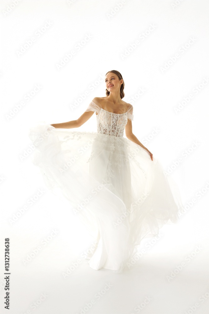 Bride twirling in a beautiful wedding dress against a bright white background capturing joy and elegance during a bridal session Bride twirling in a beautiful wedding dress against a bright white background capturing joy and elegance during a bridal session