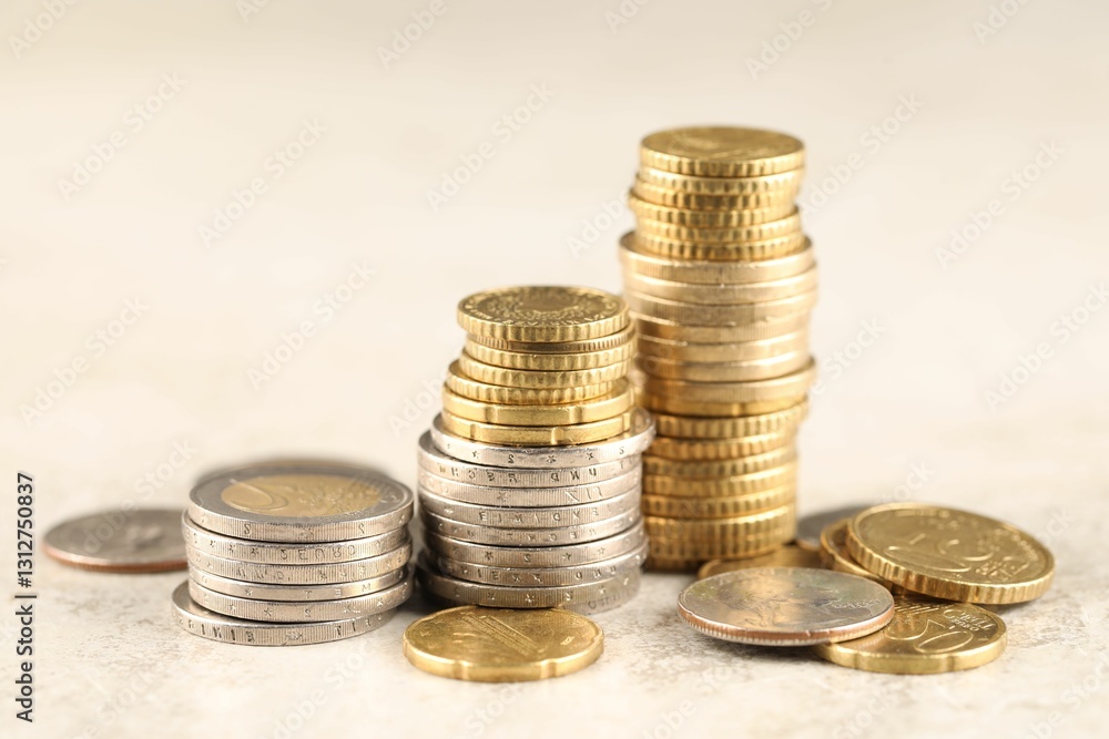 Different coins on light textured table, closeup Different coins on light textured table, closeup