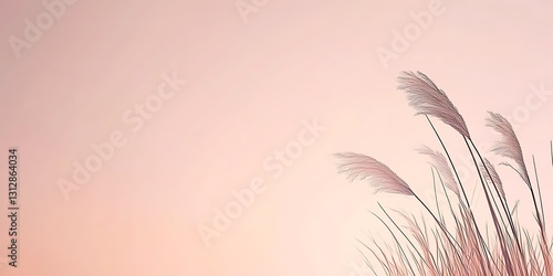 Delicate grass sways gently against a soft, pastel sky. Serene and peaceful