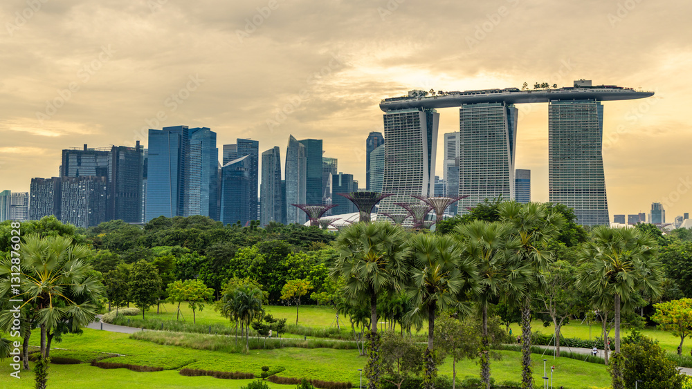 Downtown business district sunset skyline with lots of skyscrapers and green park in the foreground, Singapore Downtown business district sunset skyline with lots of skyscrapers and green park in the foreground, Singapore