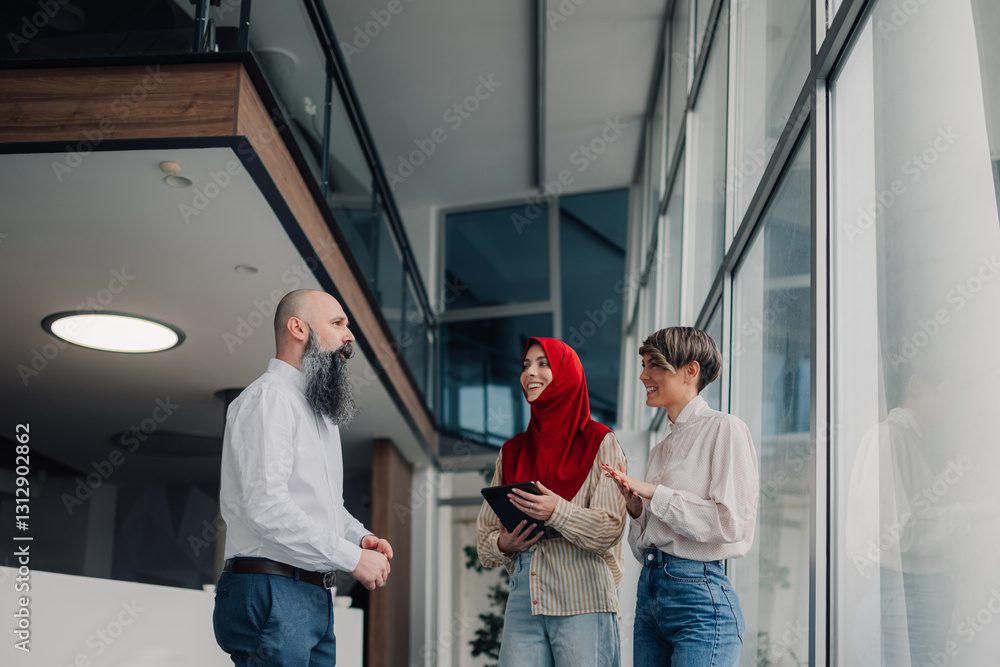 Business people collaborating in modern office building lobby Business people collaborating in modern office building lobby