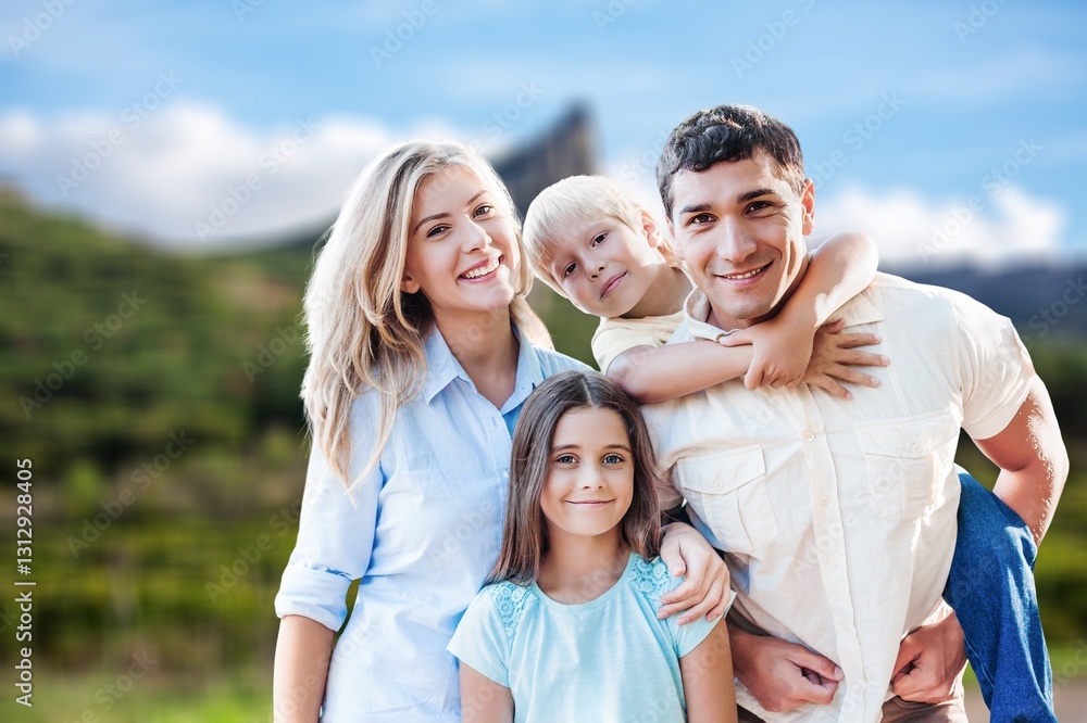 Fototapeta premium Happy young family with children at nature park background